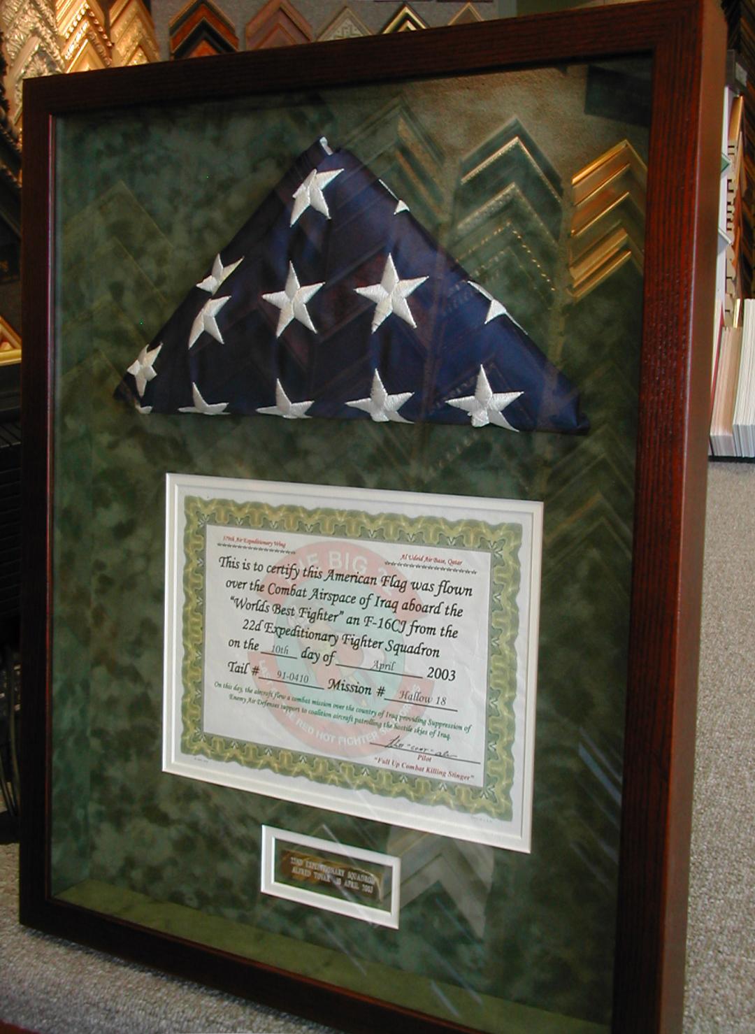 Folded American flag and certificate in a custom military shadowbox